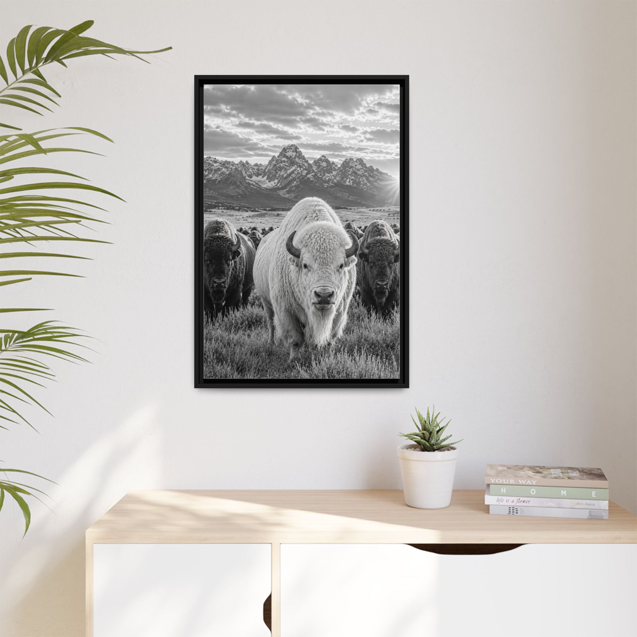 Entryway - A striking black-and-white wildlife photograph featuring a rare white bison leading its herd beneath towering mountain peaks. Bold, timeless, and rich with western character, this fine art image celebrates the power and majesty of the American wilderness.