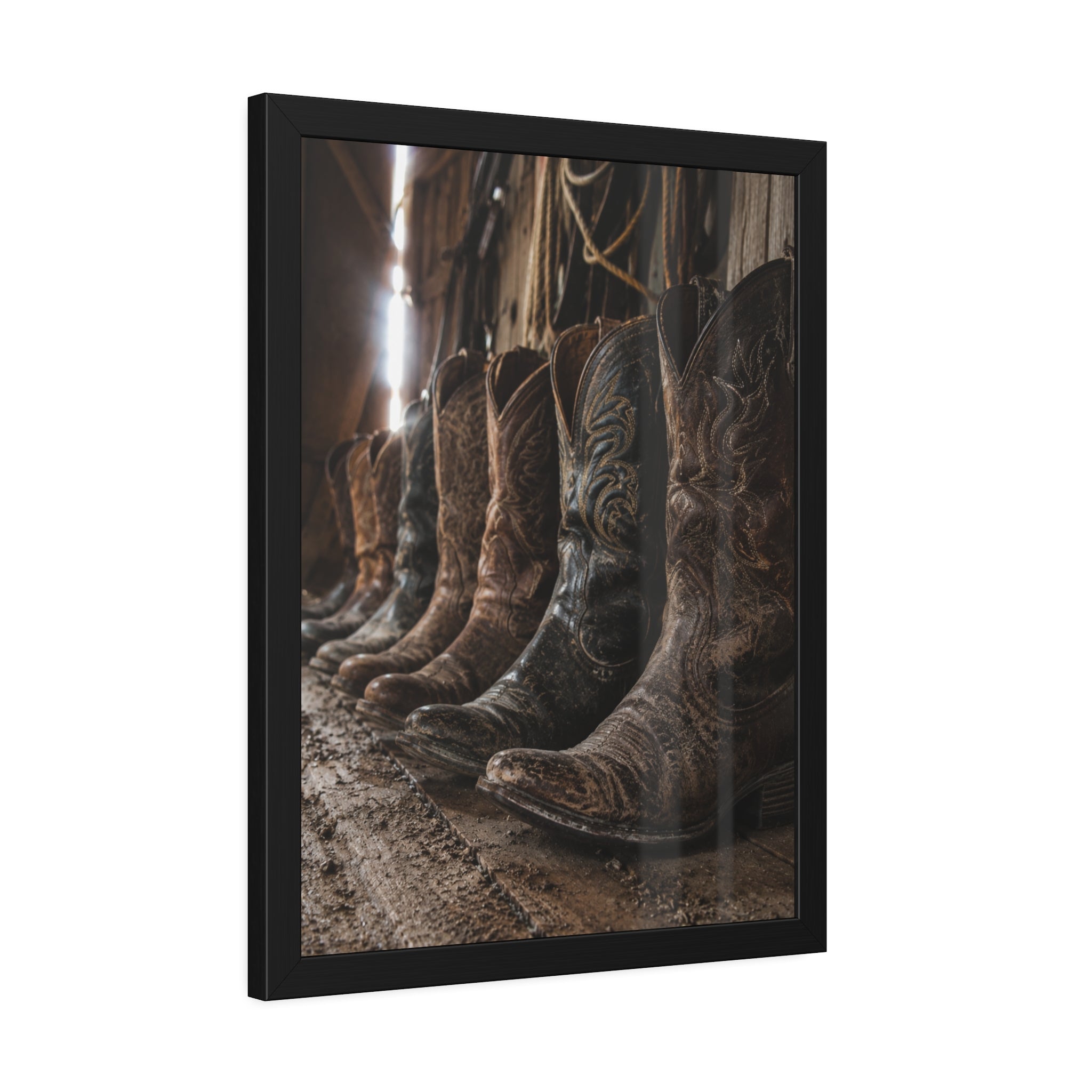 Framed Weathered cowboy boots line the floor of an old barn, capturing the rugged beauty, heritage, and timeless spirit of Western ranch life.