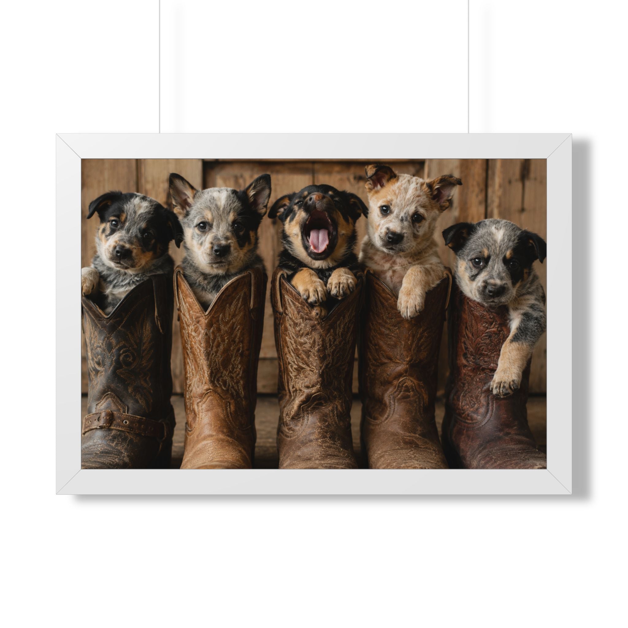 White Frame - Adorable puppies peeking from weathered cowboy boots create a heartwarming blend of Western charm, playful personalities, and rustic farmhouse style.