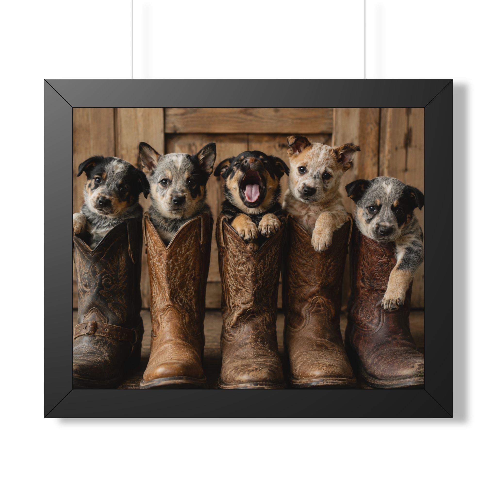 Black Frame - Adorable puppies peeking from weathered cowboy boots create a heartwarming blend of Western charm, playful personalities, and rustic farmhouse style.